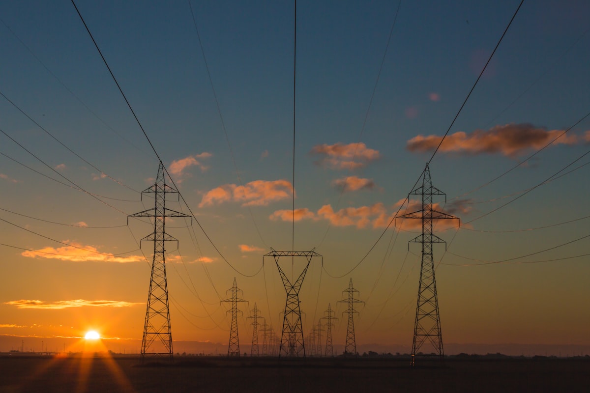 High-voltage transmission towers at sunset